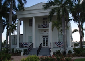 Everglades City Hall with a symmetrical facade, central entrance, and decorative railings. - Everglades Chokoloskee 3 bdrm Home w/ dock, marina, National Park,10,000 Islands (Chokoloskee)