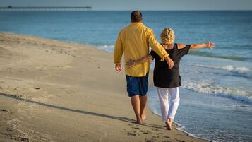 Couples can stroll hand in hand along the beach, taking in the serene ocean views.