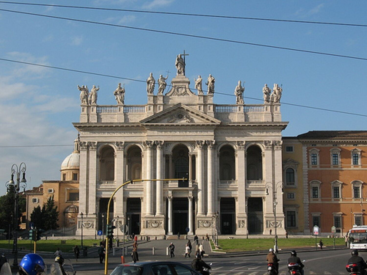 A grand historical building with classical architecture, featuring large columns and statues.