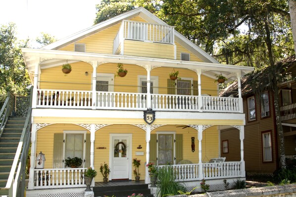 Stunning two-story building with a charming balcony and inviting front porch.