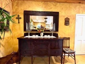 Cozy retreat with a dresser, mirror, and comfortable chair, perfect for relaxing.