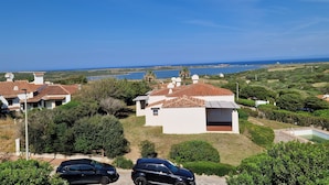 Zona residencial con casas, una piscina y vistas al mar.
