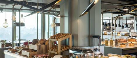 Een ontbijtbuffet met diverse broden, gebak en drankjes.