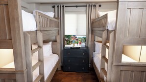 A room with two bunk beds, a wooden dresser, and a window with a view of a park. - Landmark 404 - 2 Bedroom Diamond (Vail)
