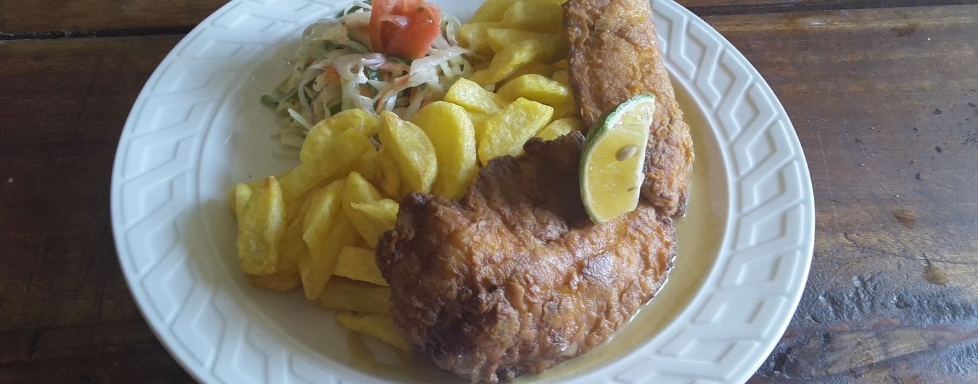 A plate with fried chicken, French fries, and a salad.