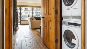 A laundry room with a sign instructing to keep the door open when using the dryer.