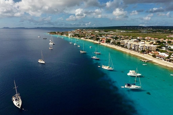 Stroll along downtown Kralendijk's vibrant malecón, where stunning views of sailboats gliding on blue waters and the picturesque Klein Bonaire await.