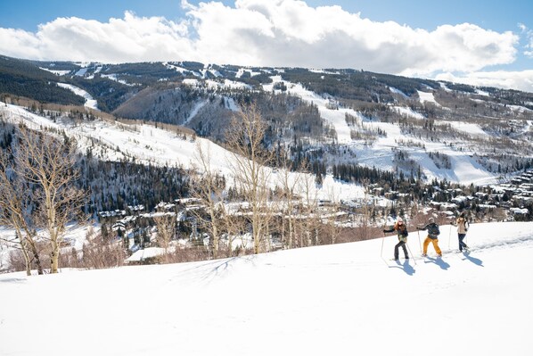 A snowy mountain landscape with a ski resort in the background.