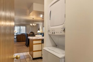 A laundry room with a washing machine, a dryer, and a small countertop with a sink. - Enzian 115 - Lionshead Vail 3BR, Minutes to Gondola + Valley Views (Vail)