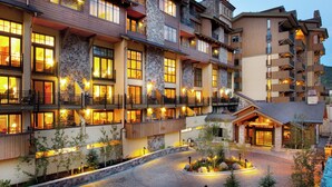 A multi-story hotel with stone and wood exterior, balconies, and a landscaped courtyard. - Landmark 304 - 2 Bedroom Platinum (Vail)