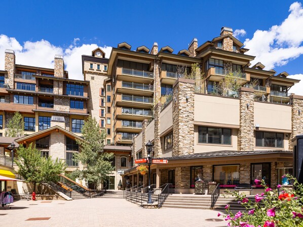 A beautifully designed alpine-style property featuring stone and wood architecture, surrounded by vibrant seasonal blooms and mountain-fresh air. This welcoming destination sets the stage for your unforgettable getaway.