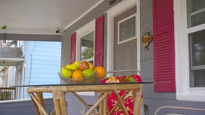 A wicker table with a fruit basket on a porch. - CORNER OF CALM IN THE ♥ OF CEDAR RAPIDS! (Cedar Rapids)