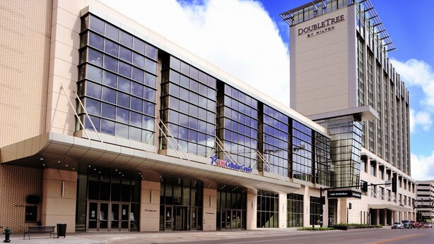 A hotel with a large glass facade, a US Cellular Center sign, and a Doubletree by Hilton sign. - CORNER OF CALM IN THE ♥ OF CEDAR RAPIDS! (Cedar Rapids)