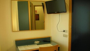 A room with a desk, chair, and a television mounted on the wall. - Hotel Palme (Monterosso al Mare)