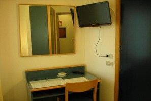 A room with a desk, chair, and a television mounted on the wall. - Hotel Palme (Monterosso al Mare)