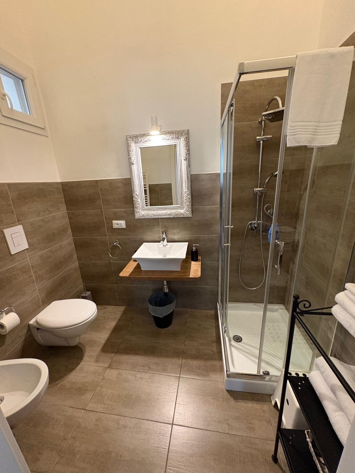 A bathroom with a toilet, sink, and shower.