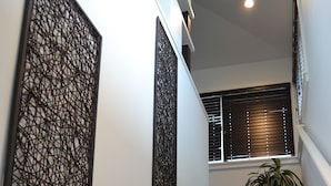 A staircase with carpeted steps leading to a landing.