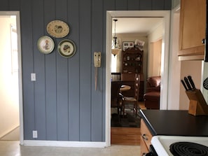 A kitchen with a stove, a wooden cabinet, and a wall-mounted telephone. - Willow Springs/Spread Out in East Nashville/Pet Friendly (Nashville)