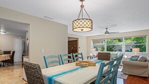 A dining area with a table, chairs, and a ceiling fan. - Gorgeous Vacation Dream Home with heated Pool (Seminole)