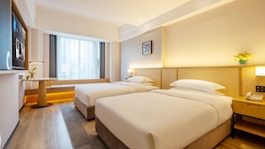 A hotel room with two beds, a desk, a TV, and a window with curtains. - Gem Flower Jinyu Sunshine Hotel (Chengdu)
