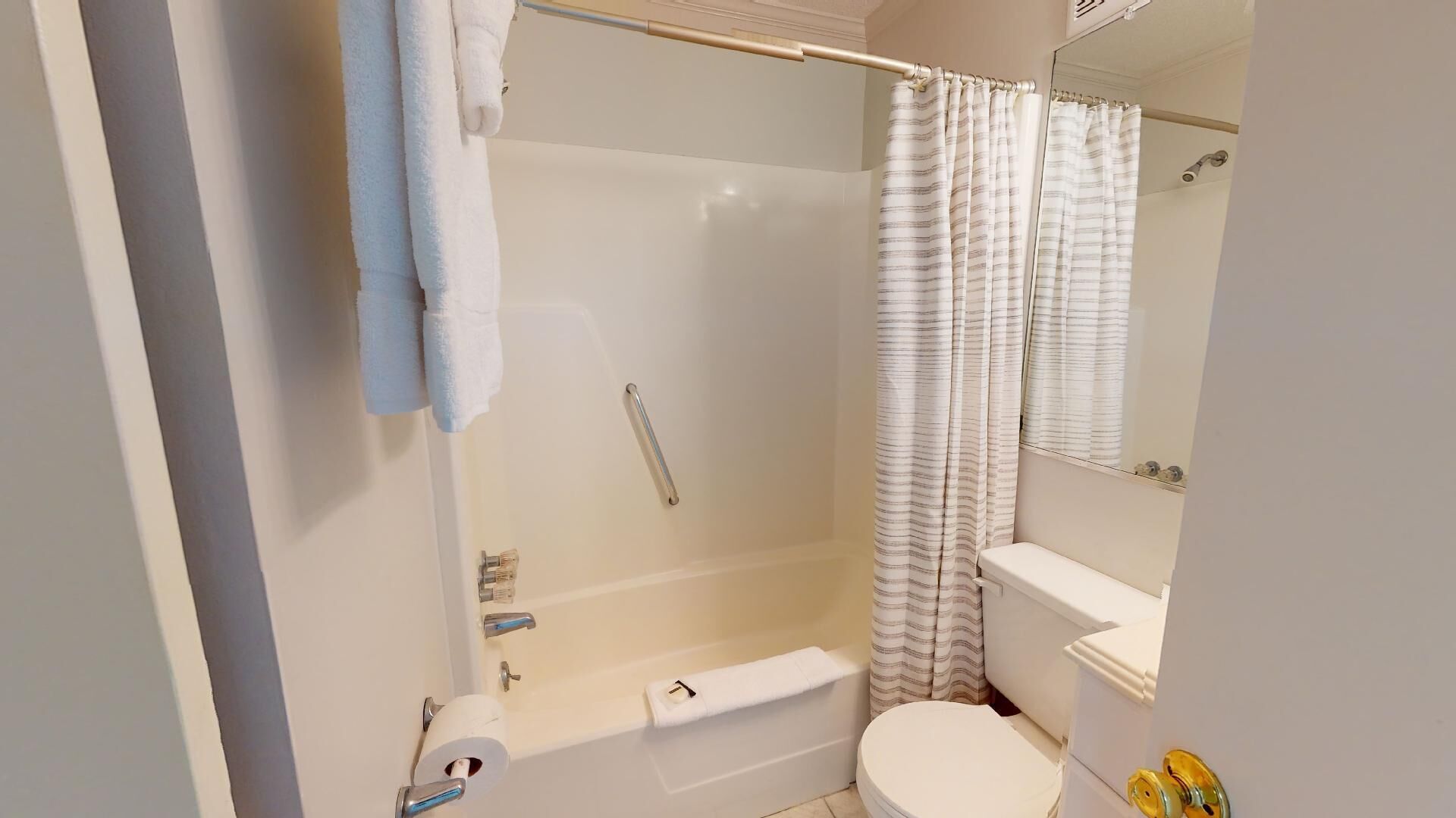A bathroom with a shower, toilet, and sink.