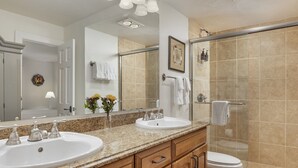 A modern bathroom with two sinks, a shower, and a glass-enclosed shower area. - Vantage Point 501 - 3 Bedroom Gold (Vail)