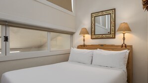 A neatly made bed with white linens, a wooden headboard, and two bedside lamps. - Vantage Point 501 - 3 Bedroom Gold (Vail)