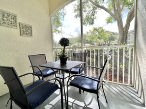 Outdoor dining - 14-105 Ground floor, HEATED POOL, lighted tennis court, gym, close to Disney (kissimmee)