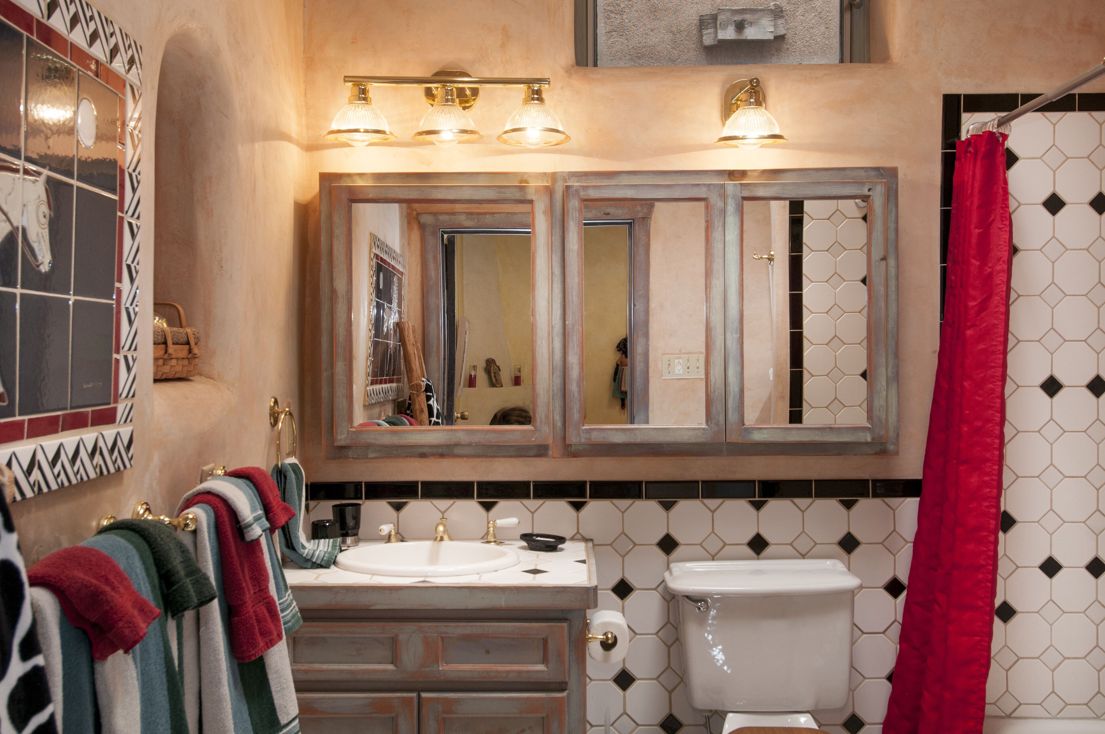 Un baño con dos lavamanos, un inodoro y una cortina de ducha.