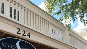 A building with a sign reading "River Suites" and the number "224".
