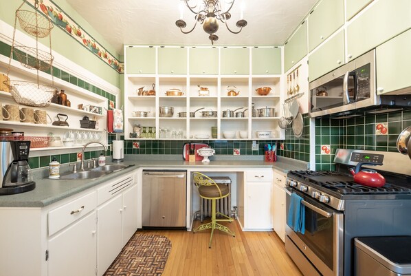 Efficient kitchen with central island, sink, stove, and ample storage.