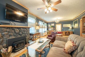 Cozy living room with a fireplace, flat-screen TV, and comfortable seating area.