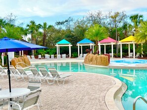 A pool area with lounge chairs, umbrellas, and gazebos. - 9-104 Legacy Dunes, Close to Disney, Heated Pool, Free Wifi & Parking (Kissimmee)