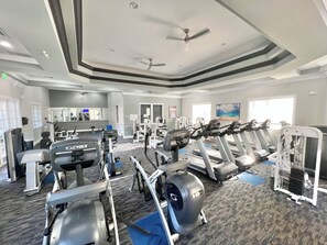 A gym with treadmills, elliptical machines, and weight equipment.