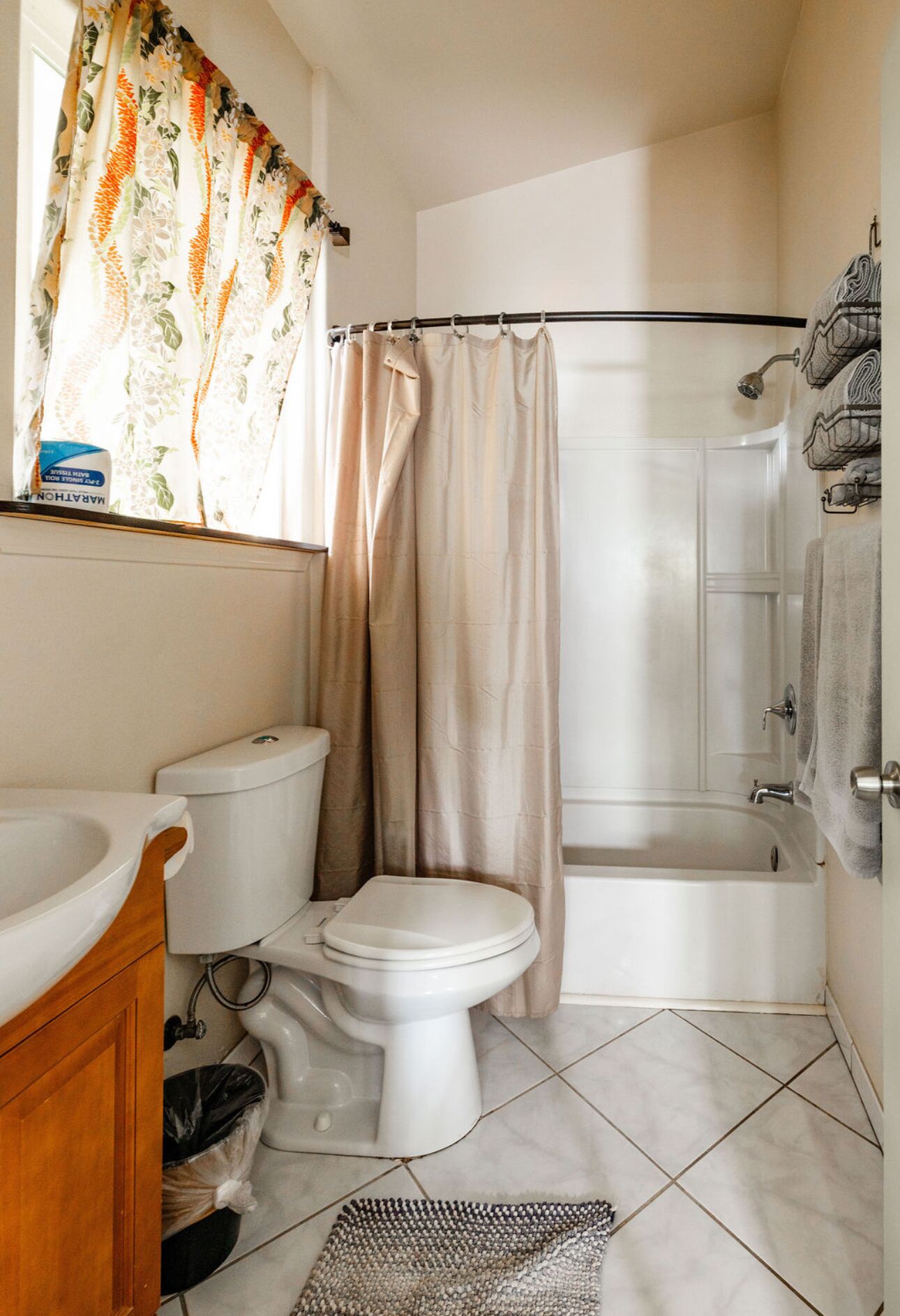 A bathroom with a toilet, bidet, bathtub, and a shower curtain.
