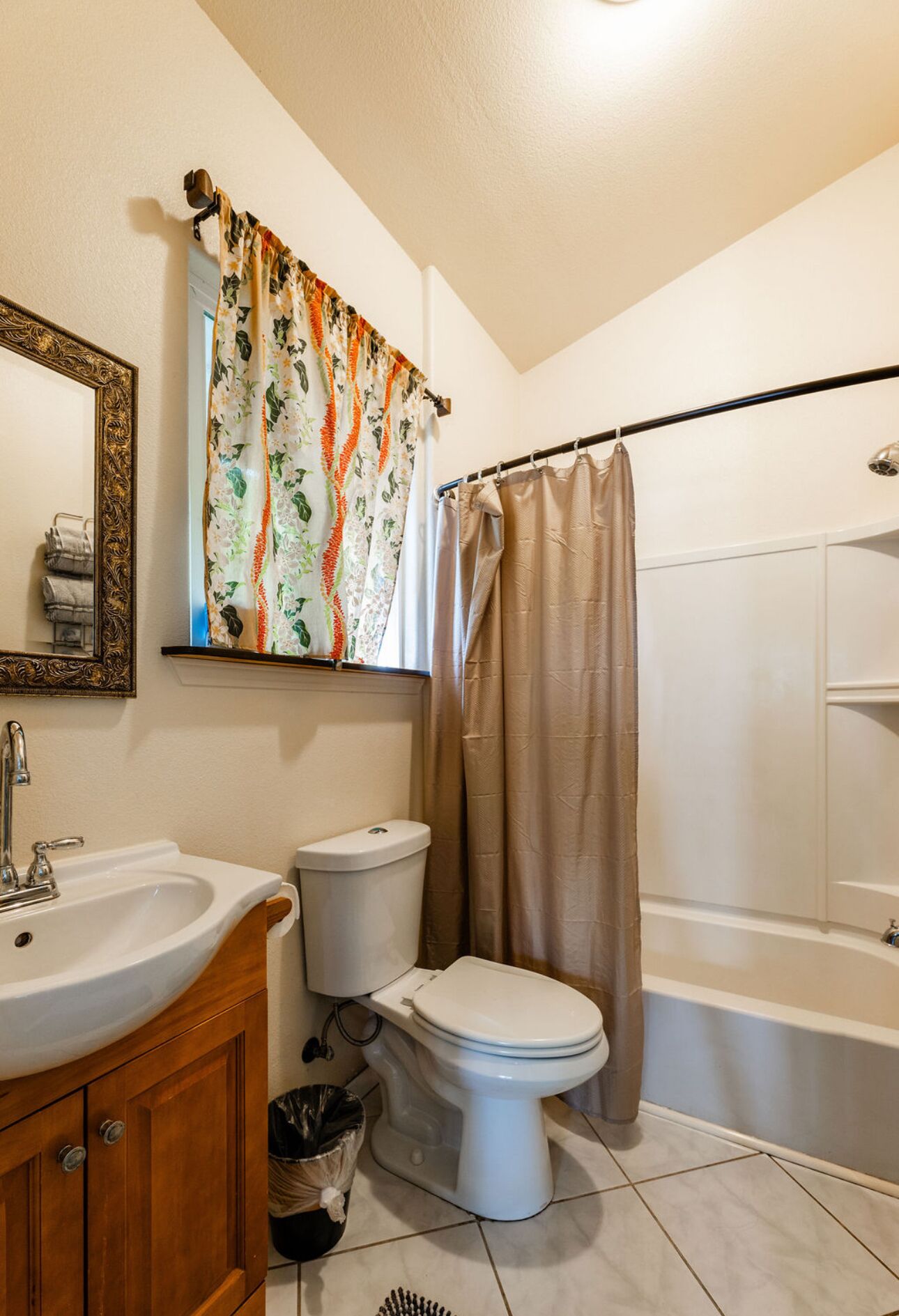 A bathroom with a sink, toilet, and bathtub.