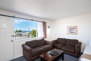 Twin Unit - Sleeps 3 | Living area | 32-inch flat-screen TV with satellite channels, TV
