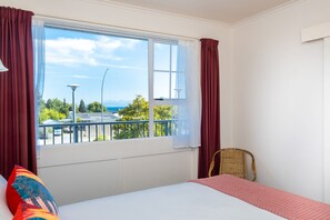 Enjoy a serene view from the large window, overlooking the balcony and surrounding landscape.