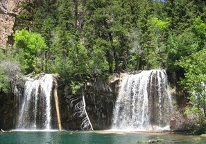 A waterfall cascading into a clear pool surrounded by dense forest. - 2 Master Suites & Great Location (Avon)