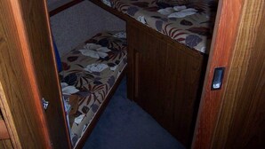 A small, enclosed space with a bench and a door. - A vacation you won't forget, stay on a 35 foot boat! (Bayfield)