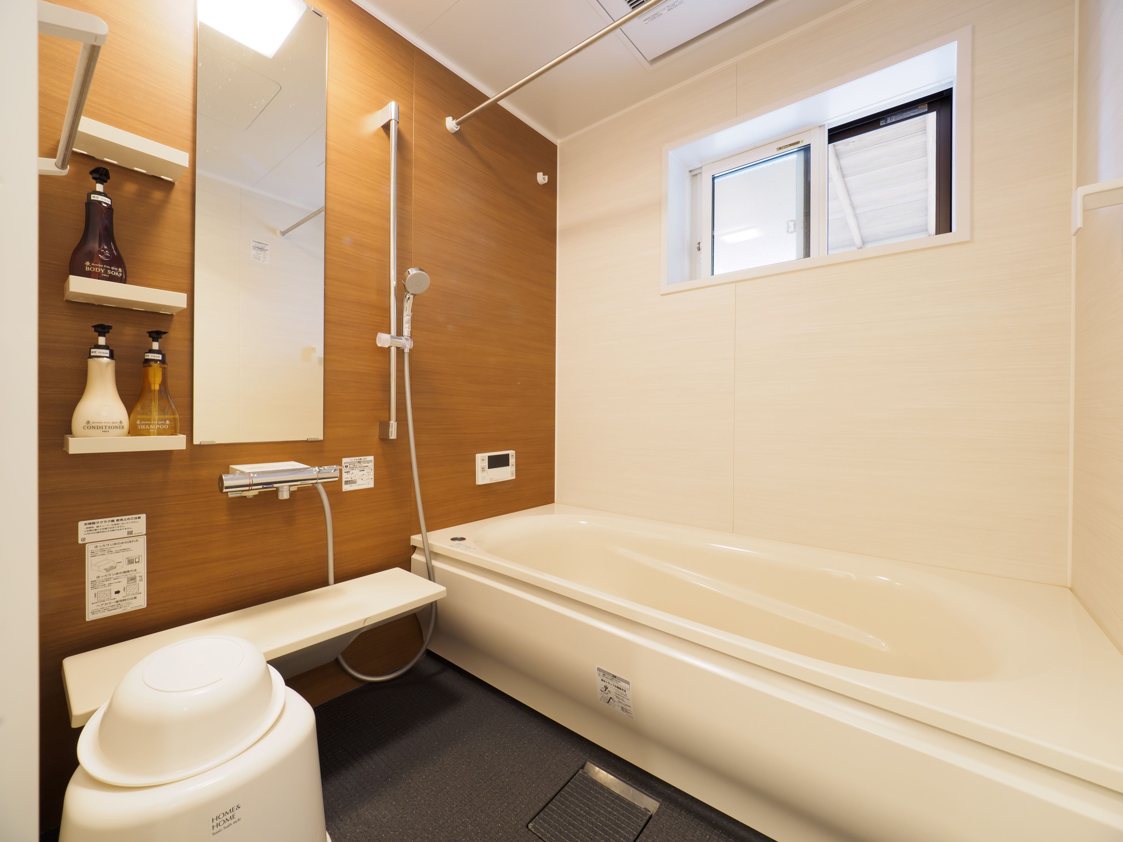 A modern bathroom with a bathtub, a shower, and a vanity with a mirror.