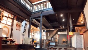A traditional Japanese interior with tatami flooring, a wooden staircase, and a shoji screen. - Monzen Okagero (Ikoma)