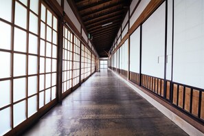 A corridor with wooden beams, large windows, and a polished floor. - Koyasan Syukubo Zofukuin (Koya)
