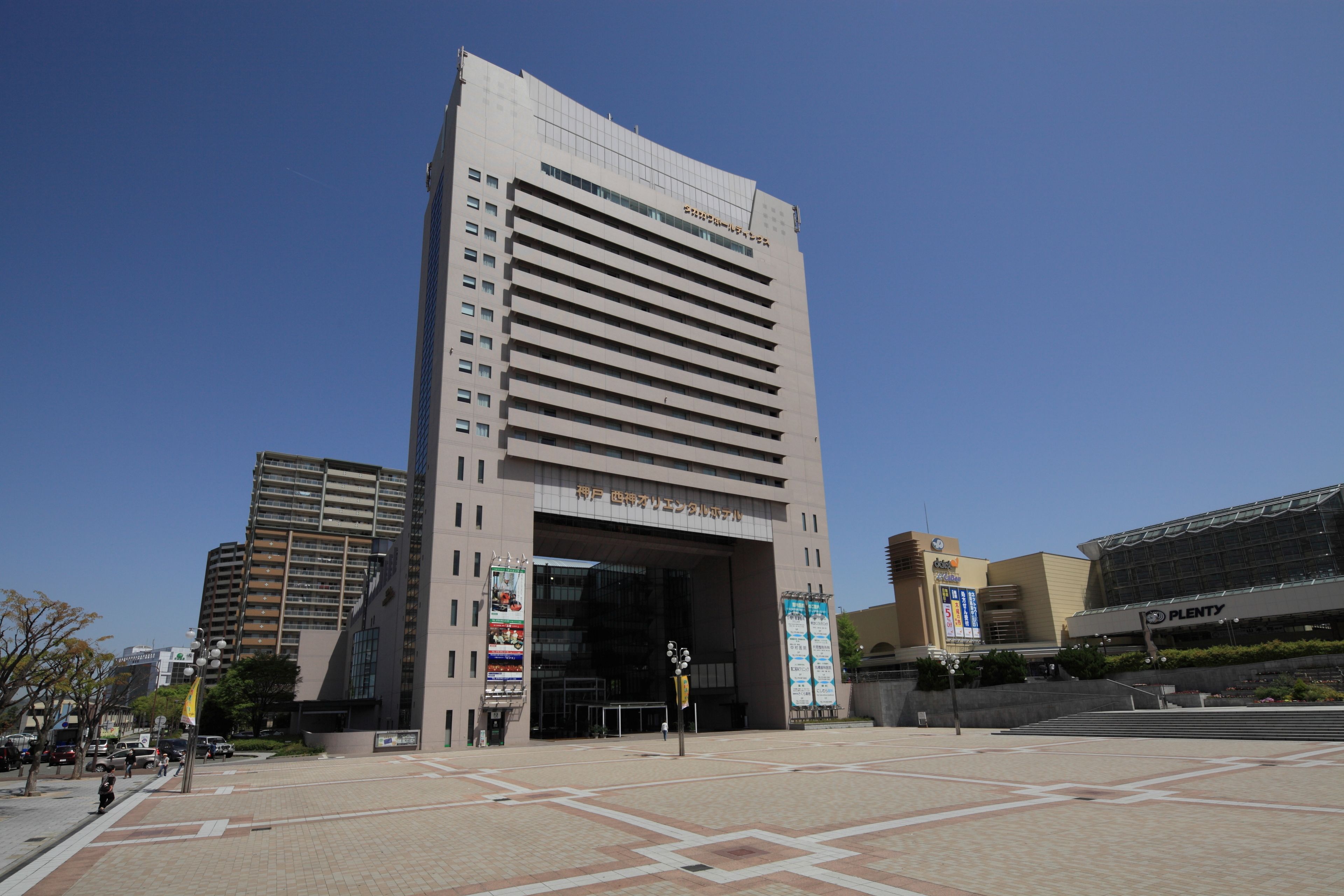 A modern building with a large entrance and multiple floors.