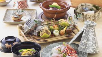 A variety of dishes and utensils on a table, including bowls, plates, and a teapot.