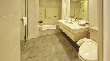 A modern bathroom with a glass shower enclosure, a vanity with a sink and mirror, and a toilet.
