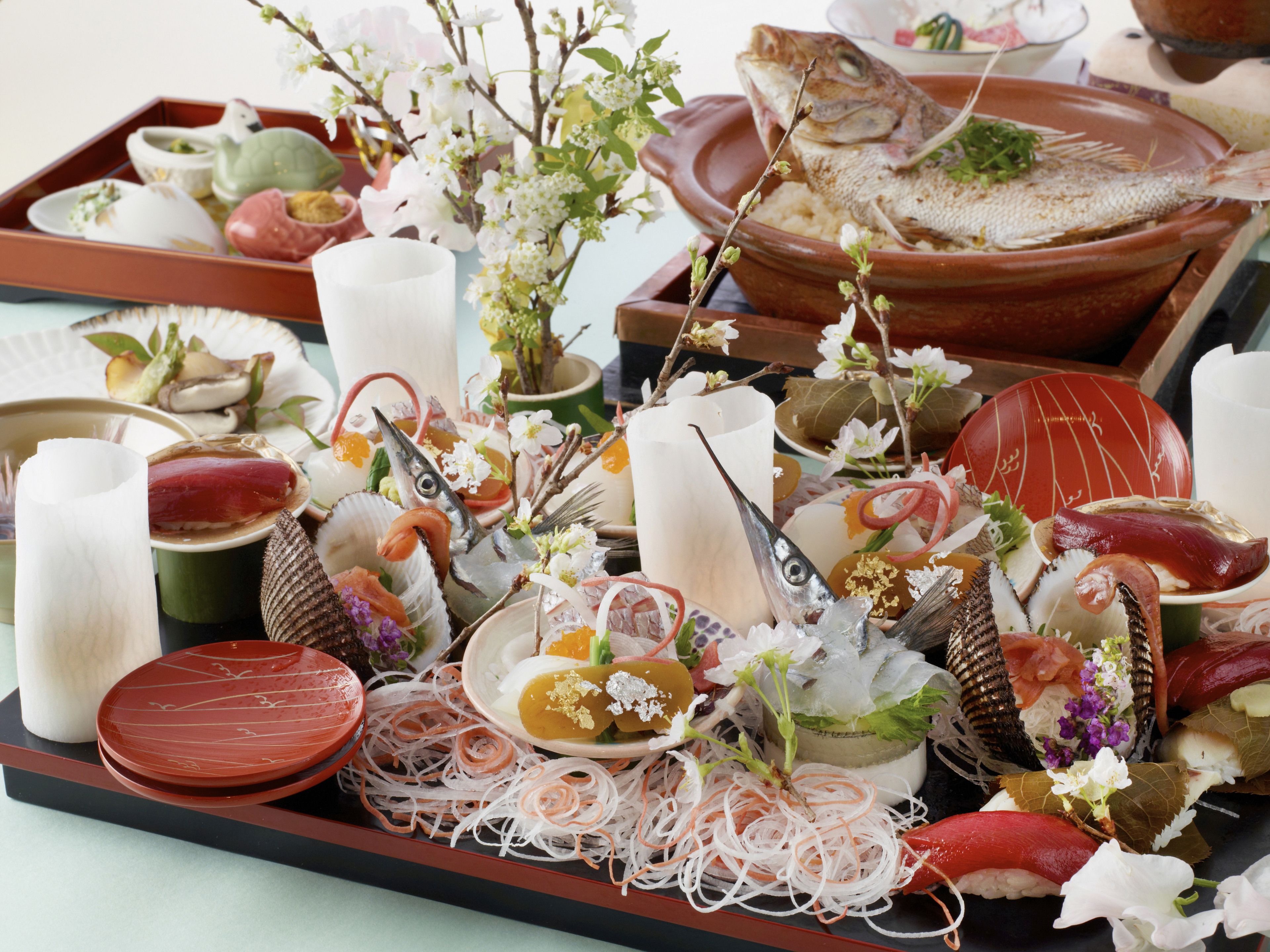 A variety of seafood dishes and utensils on a tray.
