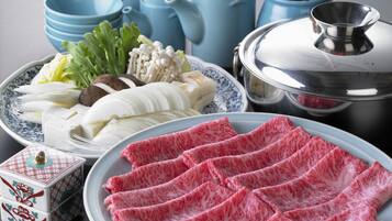A table with various food items, including sliced meat, vegetables, and a decorative box.