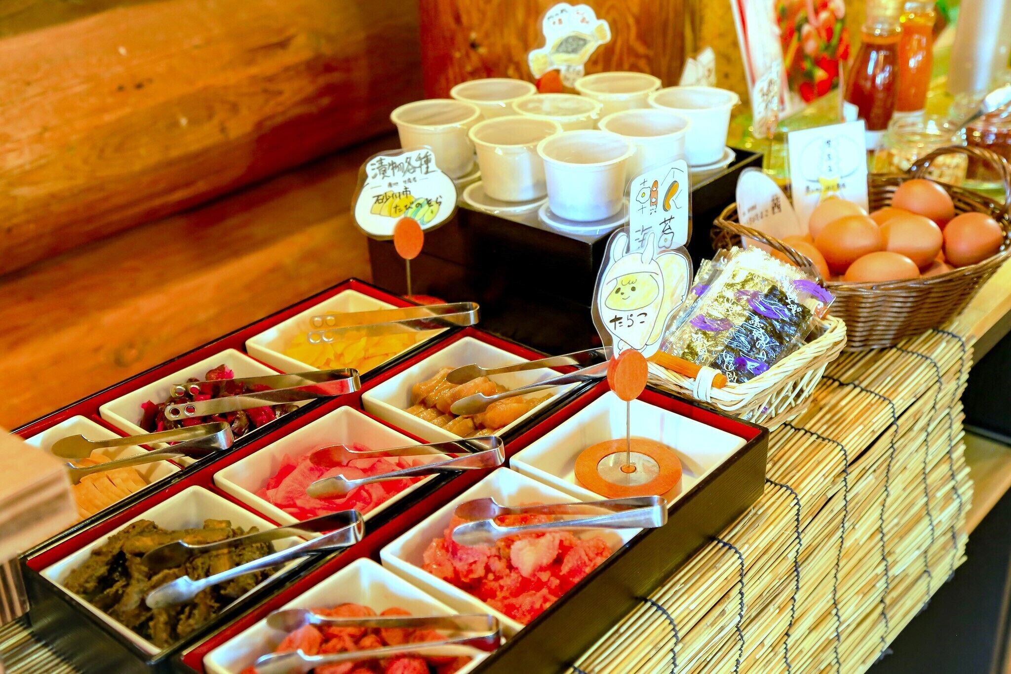 A buffet with various food items and utensils.