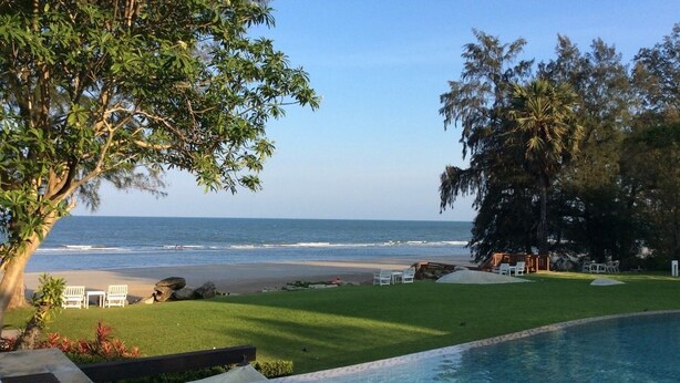 A poolside view with a beach and ocean in the background. - Away Baan Nub Kluen Beachfront at HuaHin (Hua Hin)
